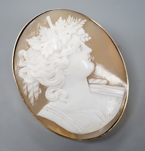 A yellow metal mounted oval cameo shell brooch, carved with the bust of a lady to sinister, 47mm, gross weight 16.7 grams.